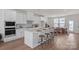 Modern kitchen with white cabinetry, quartz countertops, and stainless steel appliances adjacent to dining area at 9212 Delancey Ln # 63, Concord, NC 28027