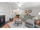 Open-concept living room with fireplace, gray sectional, and view to the dining area at 9214 Arbourgate Meadows Ln, Charlotte, NC 28277