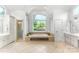 Bright bathroom showcasing garden tub beneath large window, with vanity and shower at 929 Blacksnake Rd, Stanley, NC 28164