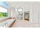Spacious bathroom featuring a tub under bright window with a separate shower and double vanity at 929 Blacksnake Rd, Stanley, NC 28164
