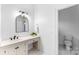 Bathroom featuring vanity with white counter, dark hardware, and a separate toilet room at 929 Blacksnake Rd, Stanley, NC 28164