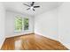 Bright bedroom boasts hardwood floors, a modern ceiling fan, and natural light from the window at 929 Blacksnake Rd, Stanley, NC 28164