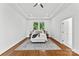Bright bedroom featuring a tray ceiling, hardwood floors, and ample natural light at 929 Blacksnake Rd, Stanley, NC 28164