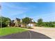 Lovely home with a spacious driveway and attached garages, set against a backdrop of mature trees at 929 Blacksnake Rd, Stanley, NC 28164