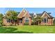 Charming brick home showcasing well-manicured lawn and inviting front entrance with detailed trim at 929 Blacksnake Rd, Stanley, NC 28164