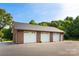 Three car detached garage with white doors at 929 Blacksnake Rd, Stanley, NC 28164