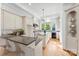 Bright kitchen features custom cabinets, stainless steel appliances, granite counters, and large arched window at 929 Blacksnake Rd, Stanley, NC 28164