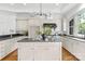 Spacious kitchen with white cabinets, a large island, stainless appliances, and hardwood flooring at 929 Blacksnake Rd, Stanley, NC 28164
