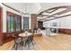 Open-concept living space featuring hardwood floors, brick fireplace, and a connecting dining area at 929 Blacksnake Rd, Stanley, NC 28164