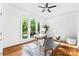 Bright home office featuring large windows, hardwood floors, a ceiling fan, and minimalist decor at 929 Blacksnake Rd, Stanley, NC 28164