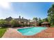Back of house view featuring a large inground swimming pool, brick patio, and gazebo at 929 Blacksnake Rd, Stanley, NC 28164