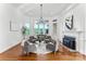 Bright sitting room with large windows, hardwood floors, fireplace and comfortable seating arrangement at 929 Blacksnake Rd, Stanley, NC 28164