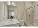Bright bathroom with a white vanity, an updated shower, and a large mirror at 9507 Pointer Rd, Huntersville, NC 28078