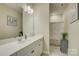 Bright bathroom featuring white cabinetry, a large mirror, and a tiled shower at 9507 Pointer Rd, Huntersville, NC 28078
