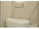 This bathroom features a soaking tub with tile flooring and neutral paint at 9507 Pointer Rd, Huntersville, NC 28078