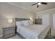 Neutral bedroom with ceiling fan features a large bed with coordinated end tables, bedding and neutral paint at 9507 Pointer Rd, Huntersville, NC 28078