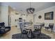 Bright dining area with a modern chandelier, open to a white kitchen with pendant lights at 9507 Pointer Rd, Huntersville, NC 28078