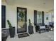 Inviting front porch with seating, plants, and a welcoming 'hello' doormat at 9507 Pointer Rd, Huntersville, NC 28078