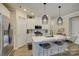 Bright, modern kitchen with stainless steel appliances, a large island, and stylish pendant lights at 9507 Pointer Rd, Huntersville, NC 28078