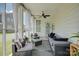 Cozy screened-in porch featuring comfortable seating and ceiling fan at 9507 Pointer Rd, Huntersville, NC 28078