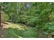 This home has a lush green backyard with mature trees and landscaping that offers privacy and serenity at 9735 Devonshire Dr, Huntersville, NC 28078