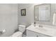 Clean and tidy bathroom featuring a vanity with a white countertop, a mirror, and a toilet at 9735 Devonshire Dr, Huntersville, NC 28078