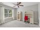 Bright bedroom features a ceiling fan, a large window, and a white desk with shelves at 9735 Devonshire Dr, Huntersville, NC 28078