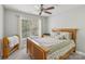 Cozy bedroom with a queen-sized bed, ceiling fan, and a large window at 9735 Devonshire Dr, Huntersville, NC 28078