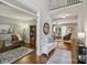 Open-concept foyer leading to the living room, study, and stairs, showcasing hardwood floors at 9735 Devonshire Dr, Huntersville, NC 28078