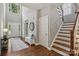 Welcoming foyer with staircase, bench, and hardwood floors provides a grand entrance at 9735 Devonshire Dr, Huntersville, NC 28078
