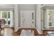 Welcoming foyer with hardwood floors, a white door, and sidelights, offering an elegant entrance at 9735 Devonshire Dr, Huntersville, NC 28078