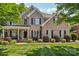 Traditional brick home with a manicured lawn and mature landscaping, enhancing its curb appeal at 9735 Devonshire Dr, Huntersville, NC 28078