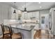 Beautiful eat-in kitchen with white cabinets, gray countertops, and stainless steel appliances at 9735 Devonshire Dr, Huntersville, NC 28078