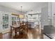 Open kitchen and dining area featuring white cabinets, hardwood floors, and access to the backyard at 9735 Devonshire Dr, Huntersville, NC 28078