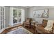 Cozy living room with hardwood floors, comfortable seating, and natural light from the large windows at 9735 Devonshire Dr, Huntersville, NC 28078