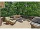 An outdoor deck with stone fireplace and a wicker chair set provides a cozy spot for relaxation at 9735 Devonshire Dr, Huntersville, NC 28078