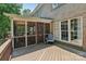A spacious porch with a screened in room featuring comfortable seating adds charm and additional living space to the home at 9735 Devonshire Dr, Huntersville, NC 28078