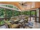 Inviting screened-in porch with vaulted ceiling and comfortable wicker seating at 9735 Devonshire Dr, Huntersville, NC 28078