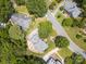 Aerial view of a house with a backyard patio surrounded by lush greenery and trees, showcasing the property's serene setting at 10500 Kilmory Ter, Charlotte, NC 28210