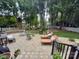 Inviting backyard patio with lounge chairs, outdoor seating, and a well-manicured lawn bordered by mature trees at 10500 Kilmory Ter, Charlotte, NC 28210