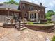 Multi-level patio featuring seating, outdoor heaters, and a beautifully landscaped yard at 10500 Kilmory Ter, Charlotte, NC 28210