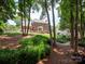 View of the house backyard, surrounded by lush greenery and mature trees at 10500 Kilmory Ter, Charlotte, NC 28210
