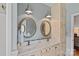Charming bathroom features a double vanity with framed mirrors and decorative lighting at 10500 Kilmory Ter, Charlotte, NC 28210