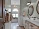 Well-lit bathroom with double vanity sinks and coordinated fixtures at 10500 Kilmory Ter, Charlotte, NC 28210