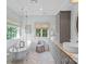 Elegant bathroom with a soaking tub, double vanity, and herringbone tile floors at 10500 Kilmory Ter, Charlotte, NC 28210