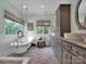 Bright bathroom features a soaking tub and vanity with a window at 10500 Kilmory Ter, Charlotte, NC 28210