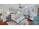 Cozy bedroom featuring hardwood floors, a ceiling fan, and natural light at 10500 Kilmory Ter, Charlotte, NC 28210