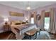 Lavish bedroom featuring a chandelier and windows providing ample natural light at 10500 Kilmory Ter, Charlotte, NC 28210