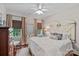 Charming bedroom features two windows for natural light, chair, and hardwood flooring at 10500 Kilmory Ter, Charlotte, NC 28210