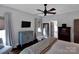 Well-lit bedroom with hardwood floors, a ceiling fan, and a calming color scheme at 10500 Kilmory Ter, Charlotte, NC 28210